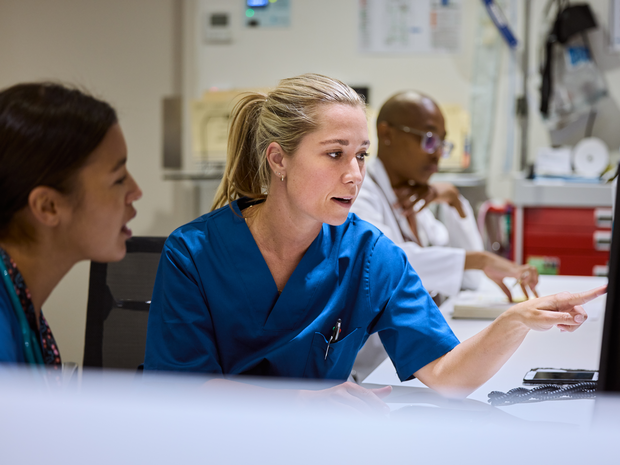 Provider points at screen in hospital.