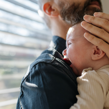 Father comforting his crying baby son