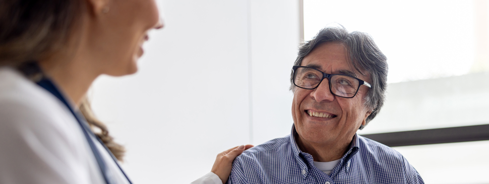 Provider with reassuring hand on patients shoulder