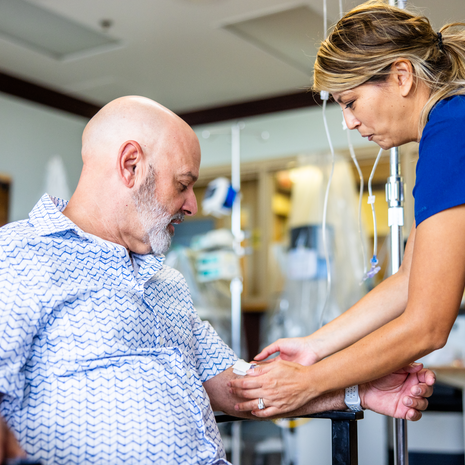 Mature male receiving infusion treatment in medical facility