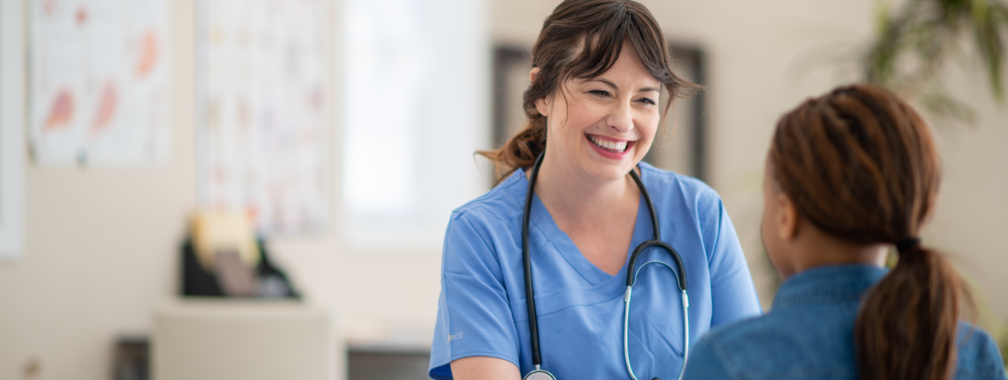 Smiling nurse communicating with a patient