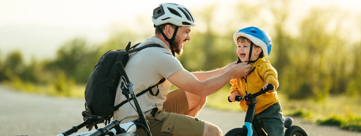 Charming family preparing for cycling on the road