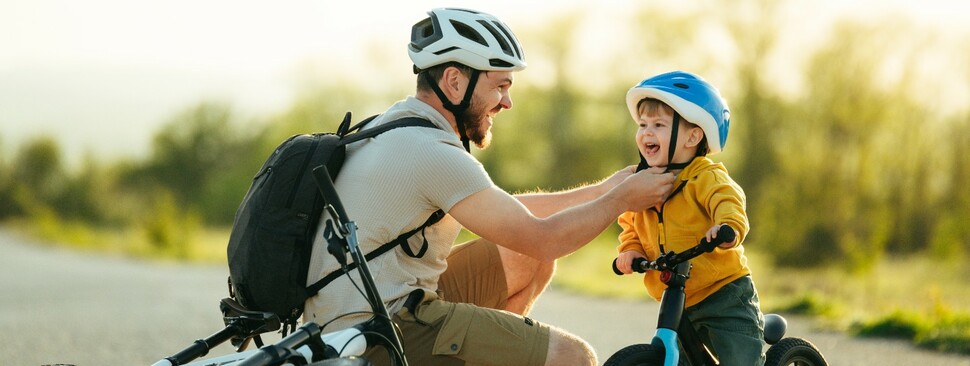 Charming family preparing for cycling on the road