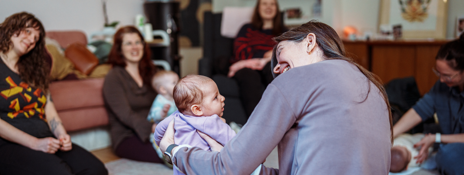 A mother looks at her infant.