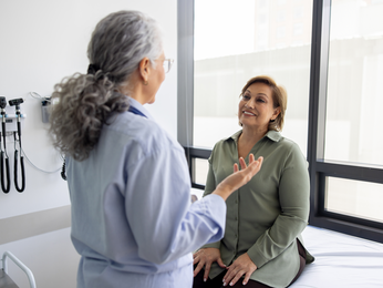 Provider talking to mature woman