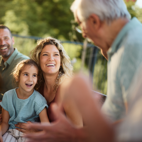 Family having dinner with grandfather on deck.