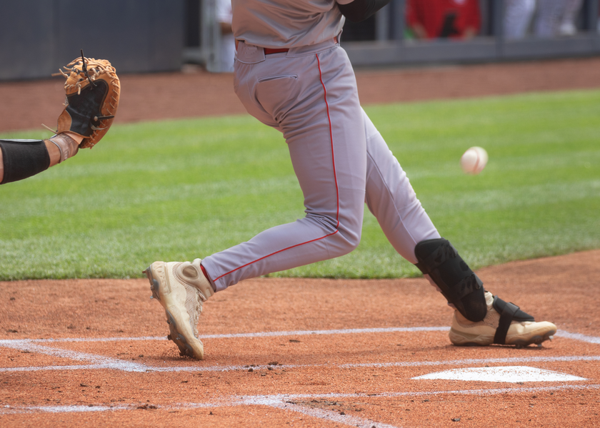 Baseball player swings and misses.