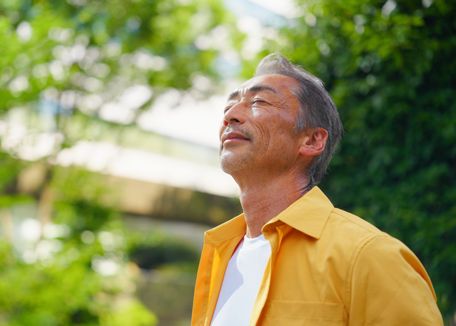 A man closes his eyes as he enjoys the outdoors