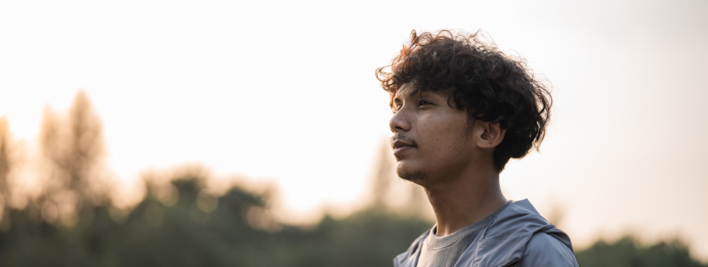 Young man with a lake in the background