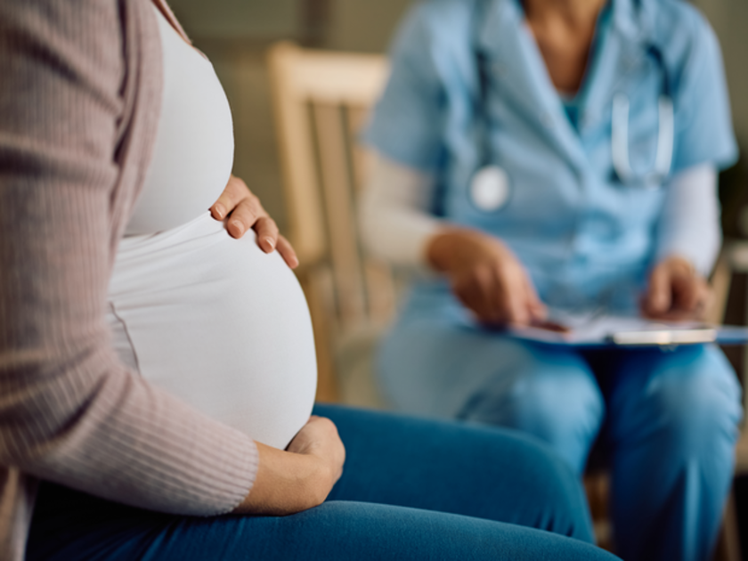 Pregnant woman speaking to a midwife