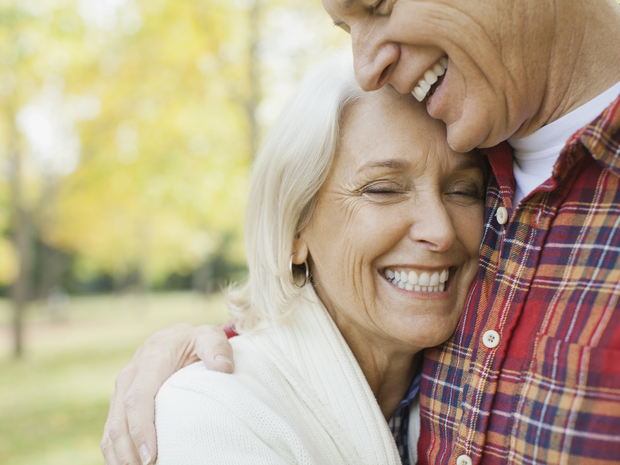 A couple happily embraces one another