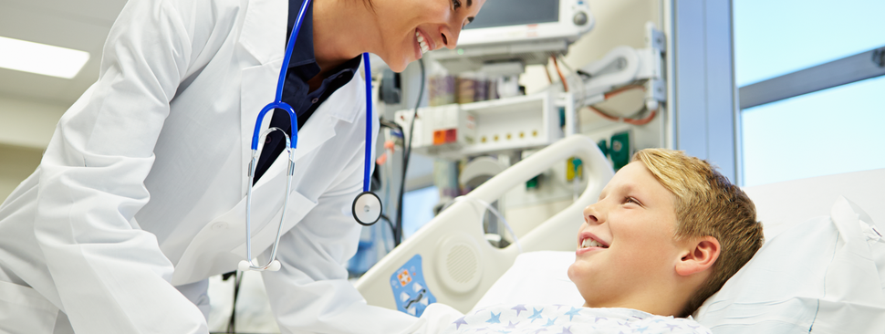 Boy talking to doctor in the hospital