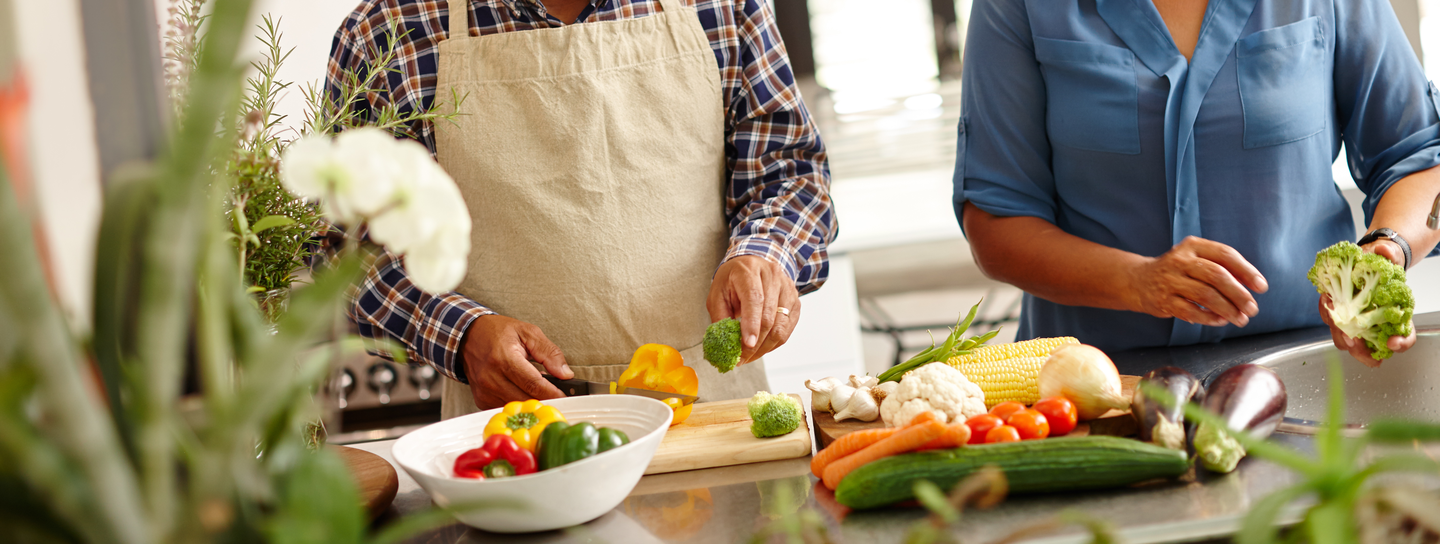 A couple cooking food together