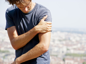Man holding his arm