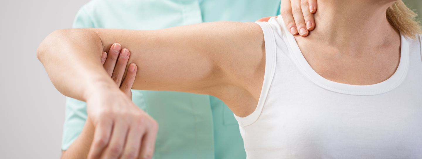 A nurse helping a patient with shoulder.