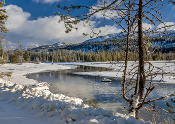 Snow covered mountain by a lake