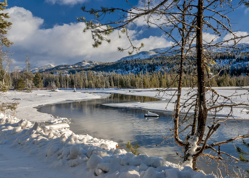 Snow covered mountain by a lake
