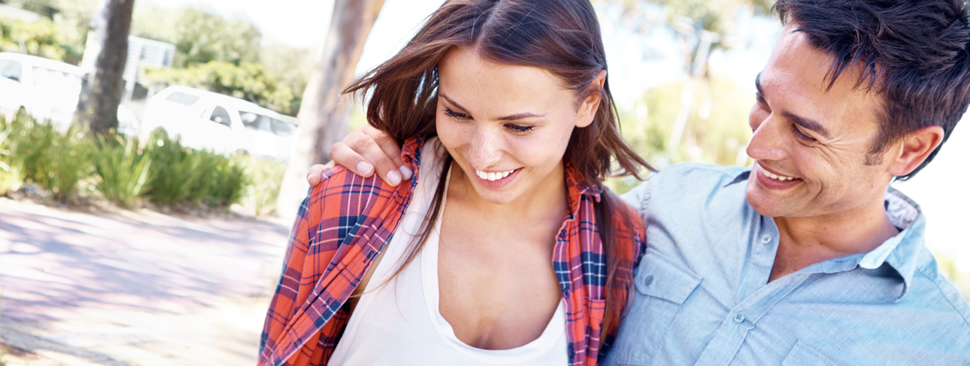 A young couple walking outside