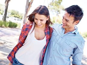 A young couple walking outside