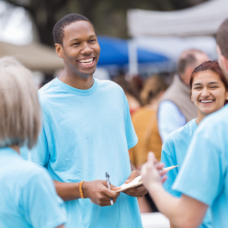Diverse group of young volunteers happy in conversation