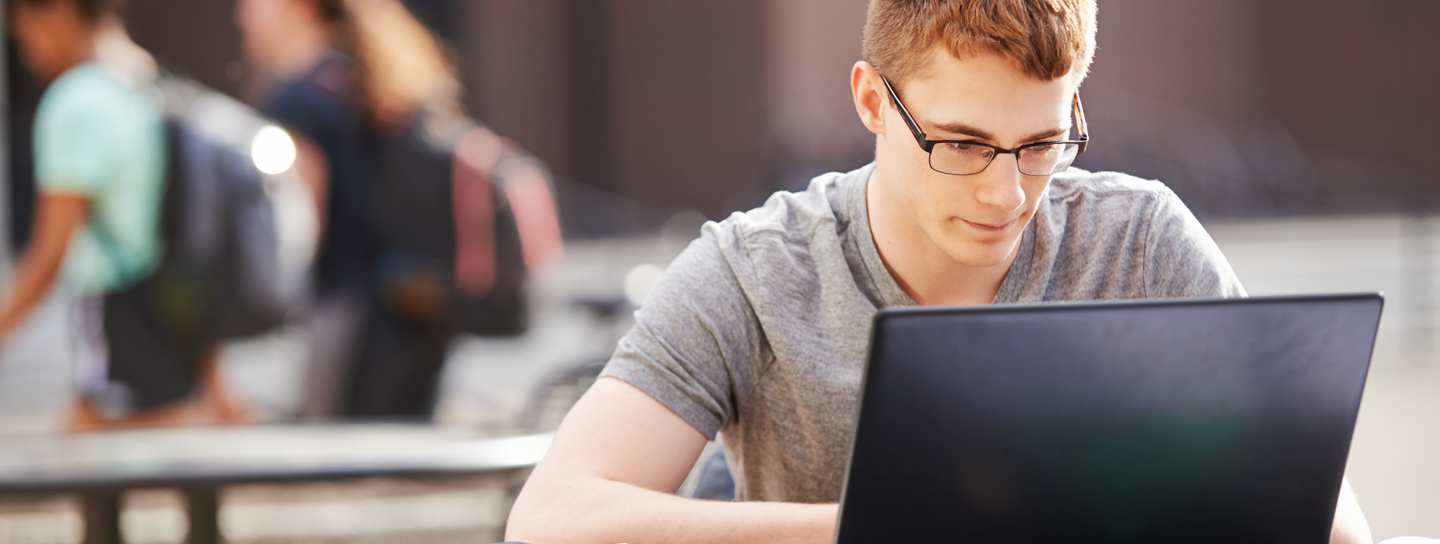 Young adult does homework on computer