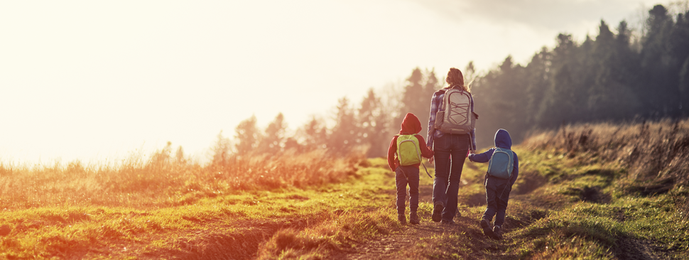 Family hikes Idaho in the sunset.