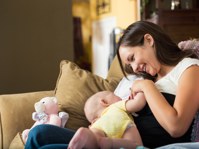 A baby feeding with mother.
