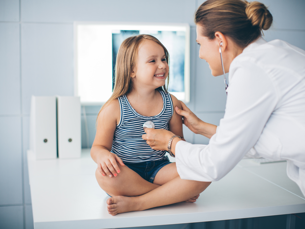 Doctor checking child’s heart