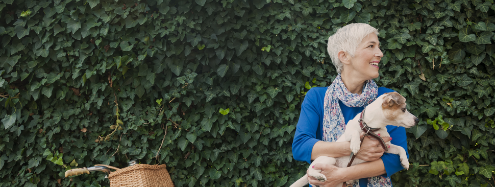 Happy woman holding a small dog