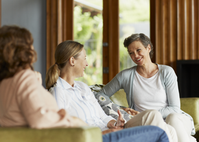 Women on a couch having a chat
