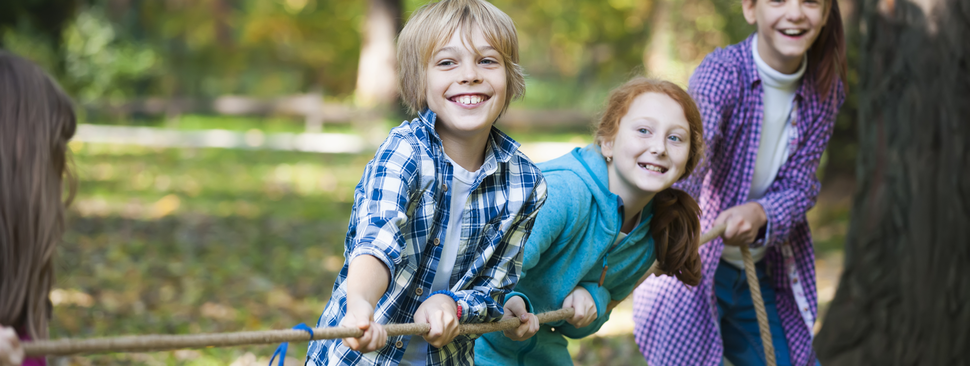 Three kids play tug of war