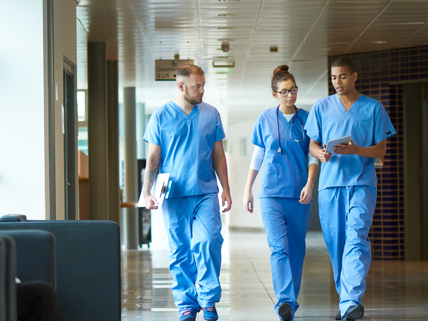 group of young nurses walking and talking