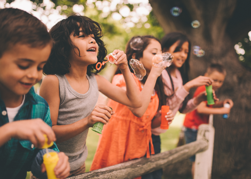 Children blow bubbles happily
