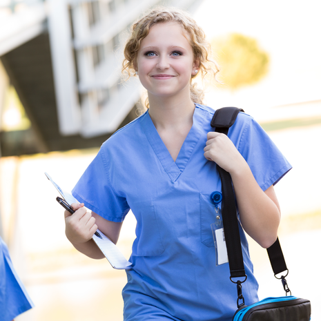 Young nurse looking purposeful on the way to work