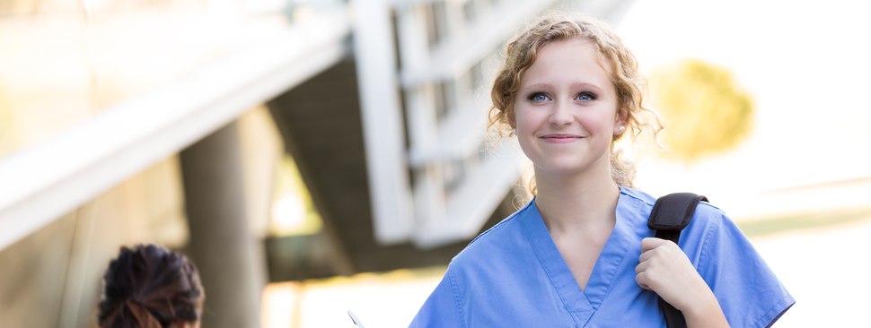 Young medical professional walks with confidence and excitement