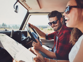 Young couple looking driving and looking at map