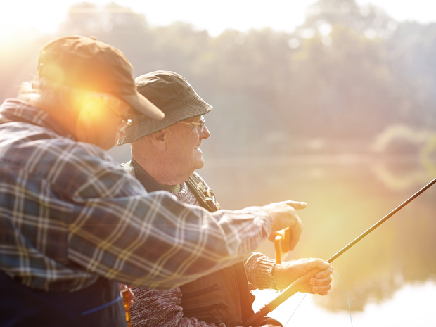 Two older men fishing on a lake