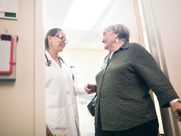 Doctor greeting an older patient