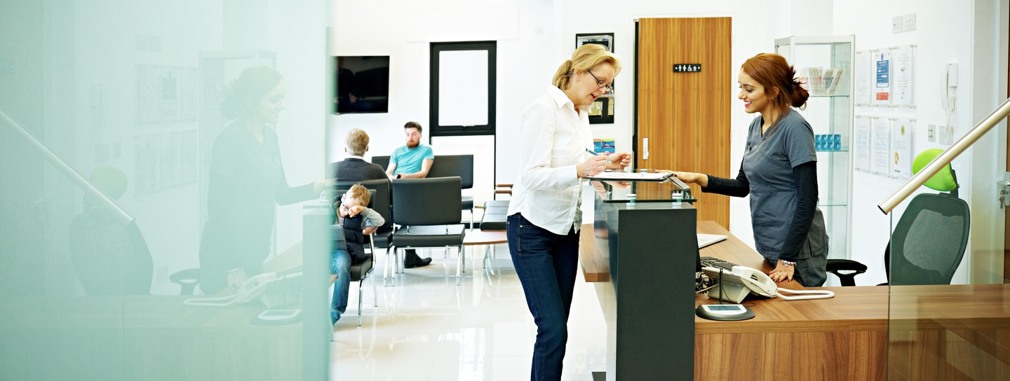 A woman checks in to a doctors appointment