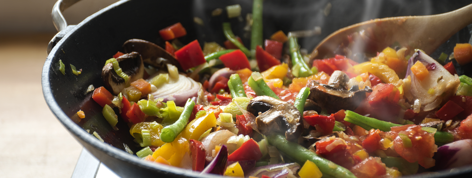 A pan full of fruits and vegetables cooking on the stove