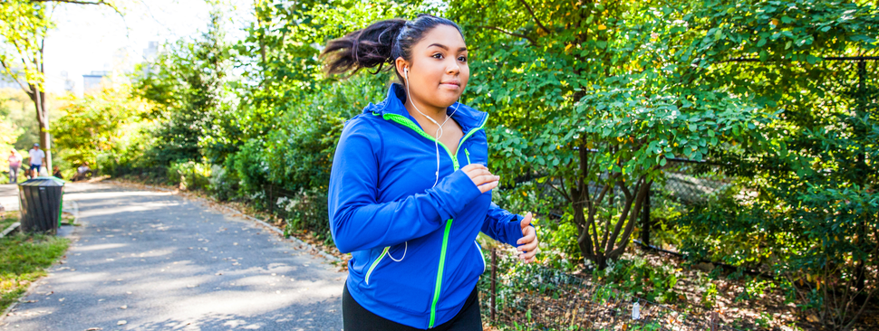 A girl running with headphones on. 