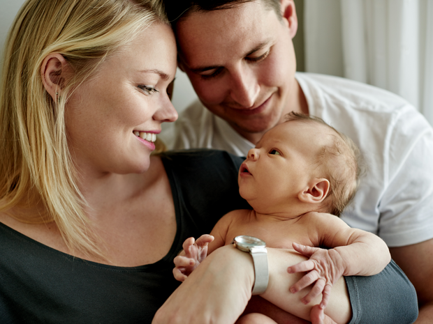young couple spending time with their newborn baby
