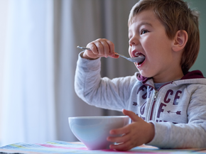 Young boy eating breakfast