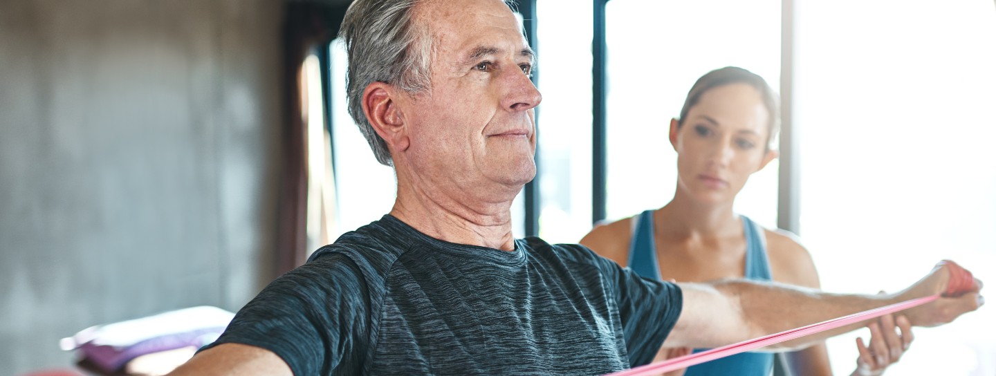 A man stretching with a band 