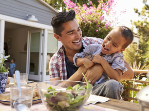 Man with his child outdoors.