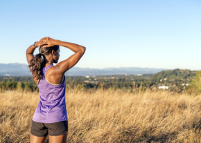 A woman stops on a run
