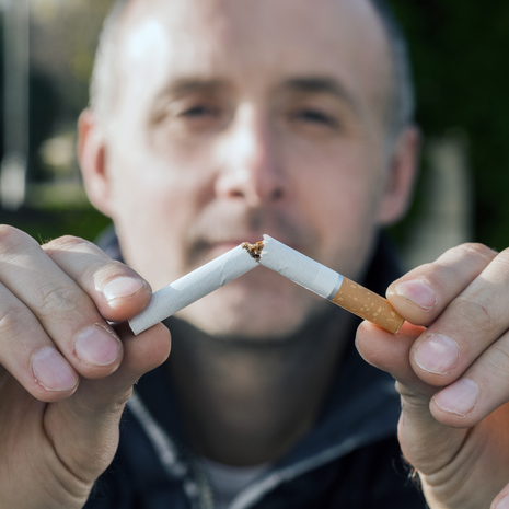 Man breaking a cigarette