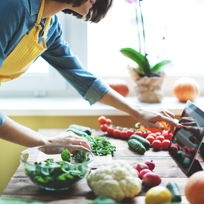 A woman looking at a recipe.