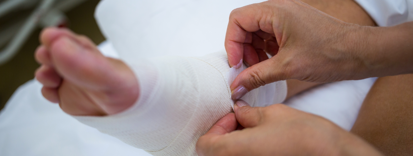 A foot being wrapped by medical bandage