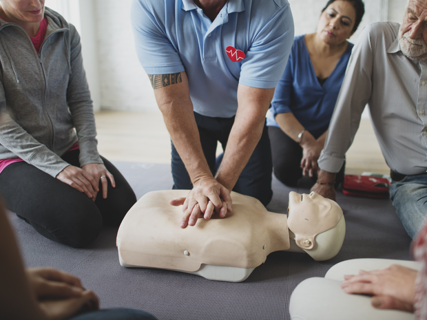 Older woman stretches in a group activity class
